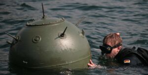 A mine diver examines a "surfaced" anchor mine. In an emergency, the divers have to get close. Photo: Bundeswehr/ Björn Wilke
