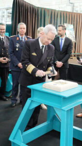 Dr Thomas Daum, the Inspector of Cyber and Information Space, nails the commemorative coin Photo: HSC