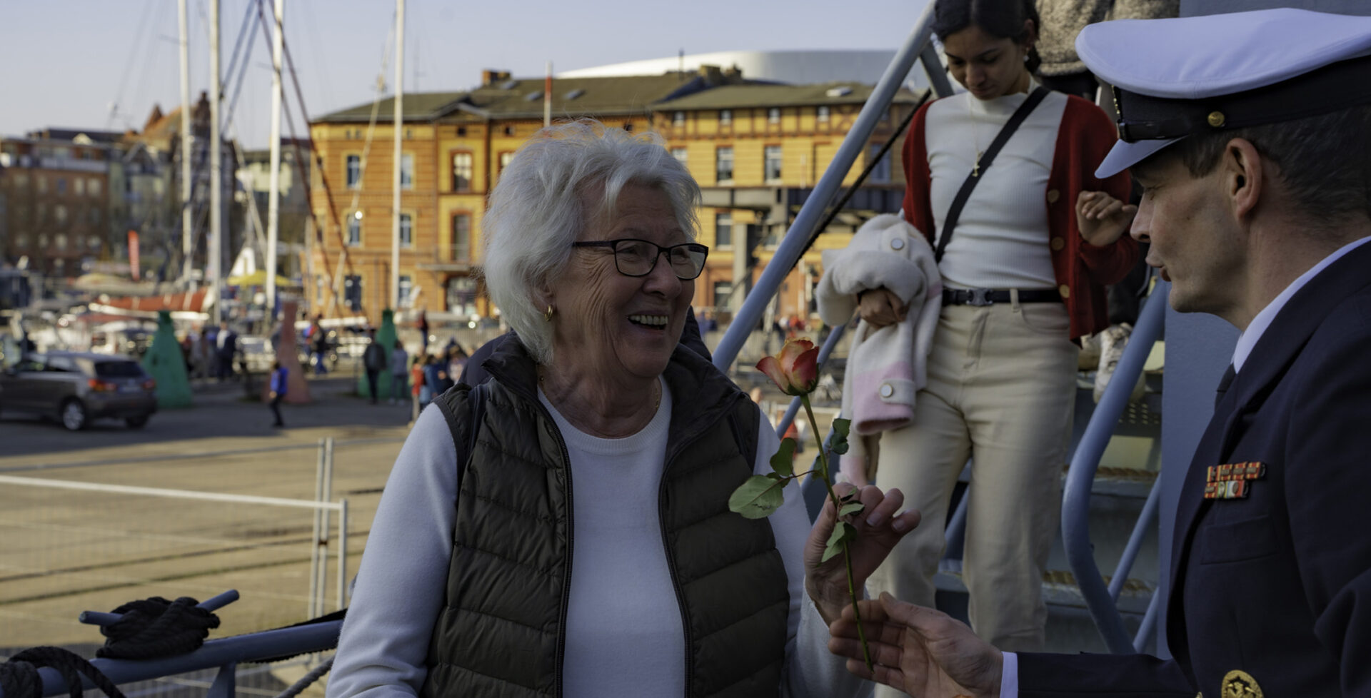 A warm welcome on International Women's Day: Naval officer presents a rose to a visitor on the tender "Donau" in Stralsund at the Open Ship. Picture: Daniel Angres