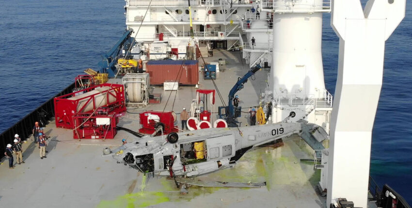 The recovered helicopter on the deck of the salvage vessel