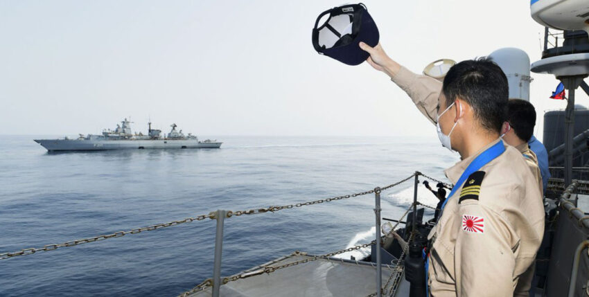 Farewell cap waving: Greetings from the Japanese destroyer