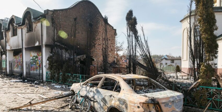 Damaged church and burnt car on the outskirts of Irpin, Ukraine