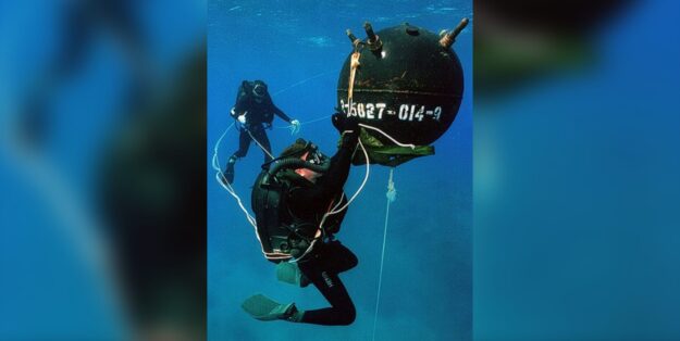 Photo: Explosive Ordnance Disposal (EOD) Divers defusing an anchor mine. U.S. Navy